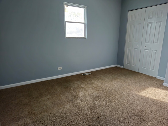 unfurnished bedroom featuring a closet and carpet floors