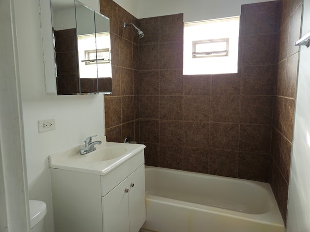 full bathroom featuring vanity, toilet, and tiled shower / bath combo