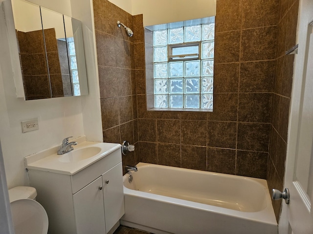 full bathroom featuring vanity, toilet, and tiled shower / bath combo