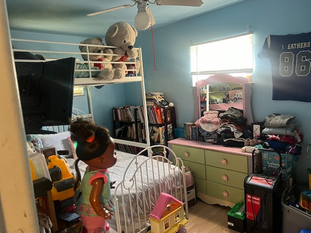 bedroom with light wood-type flooring and ceiling fan