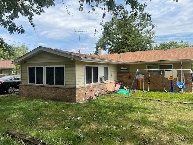 back of house featuring cooling unit and a lawn