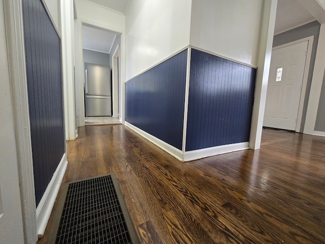 corridor with crown molding and wood-type flooring