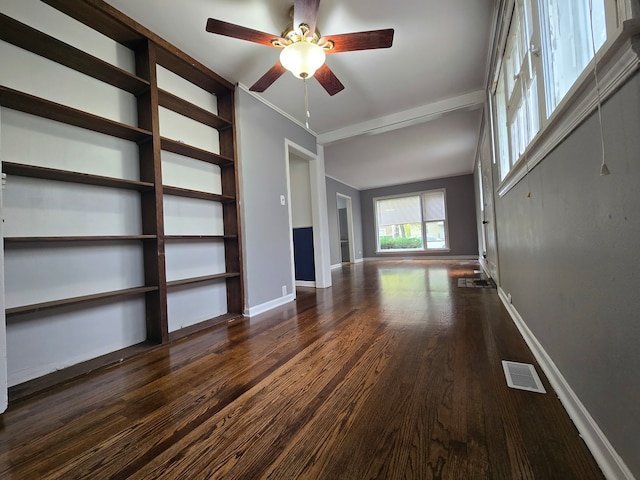 unfurnished living room featuring ceiling fan and dark hardwood / wood-style flooring