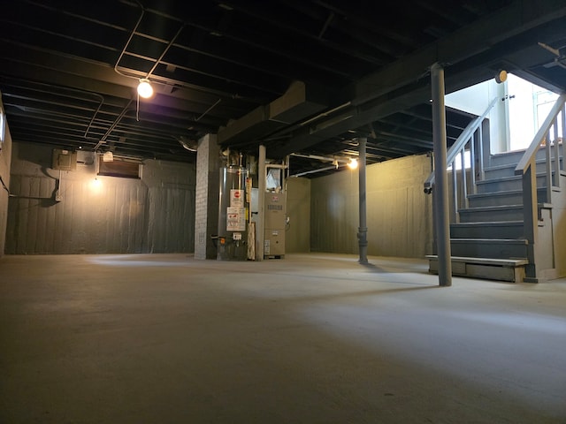 basement featuring heating unit and gas water heater