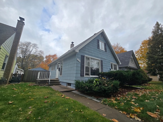 view of side of home featuring a yard