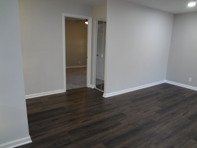 unfurnished room featuring dark hardwood / wood-style floors and ceiling fan