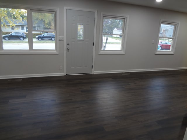 entryway with dark hardwood / wood-style flooring