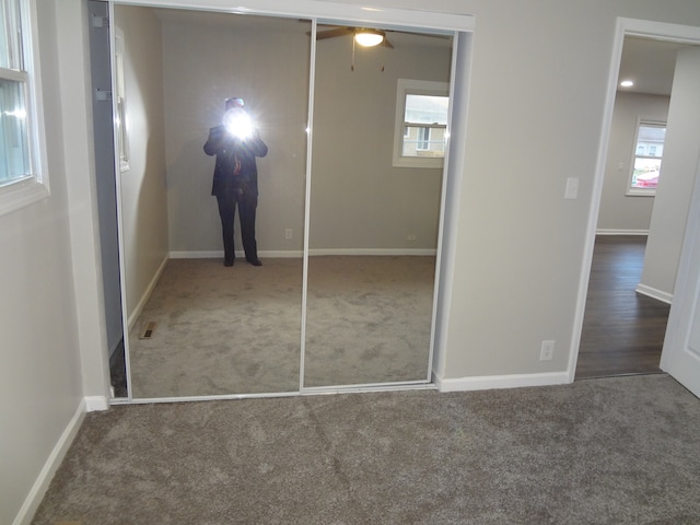 unfurnished bedroom with a closet and carpet