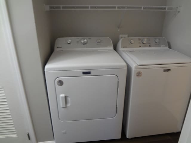 clothes washing area featuring separate washer and dryer