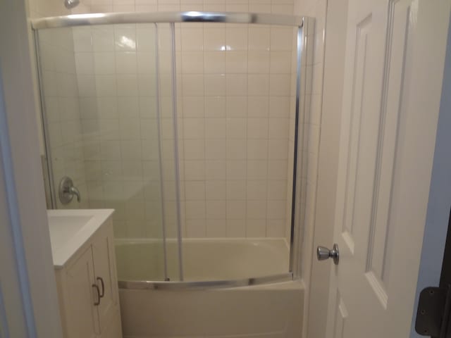 bathroom with vanity and bath / shower combo with glass door