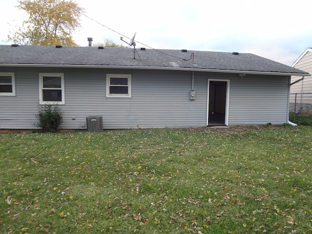 back of property featuring a yard and cooling unit