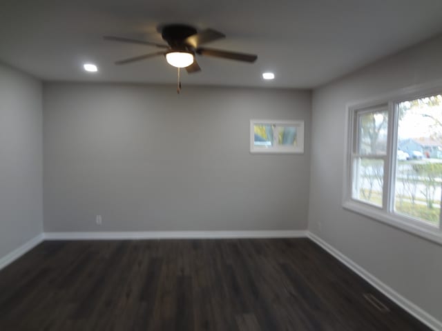 empty room featuring ceiling fan and dark hardwood / wood-style floors