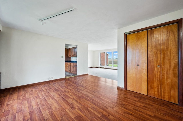 interior space with hardwood / wood-style flooring and track lighting