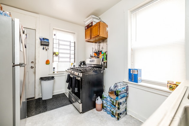 kitchen featuring white fridge and stainless steel range with gas stovetop