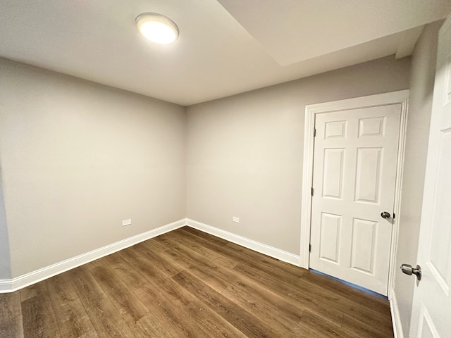 unfurnished room featuring dark hardwood / wood-style flooring