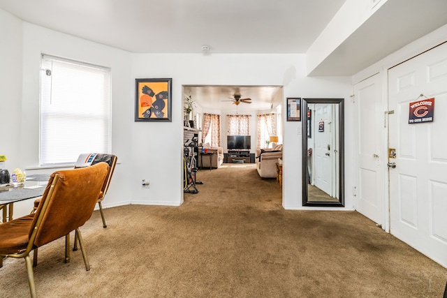 interior space with ceiling fan