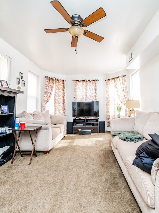 carpeted living room with ceiling fan