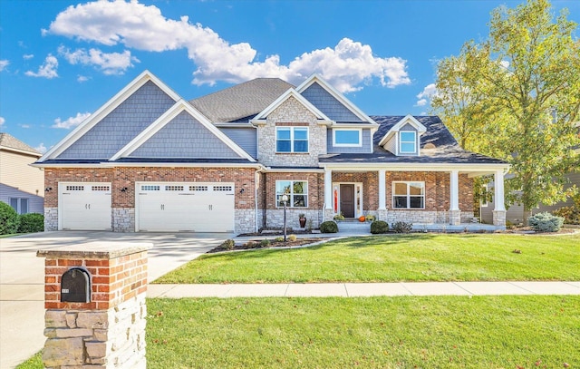 craftsman-style house with covered porch, a garage, and a front lawn