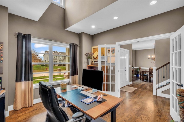 office featuring hardwood / wood-style floors, a notable chandelier, and french doors