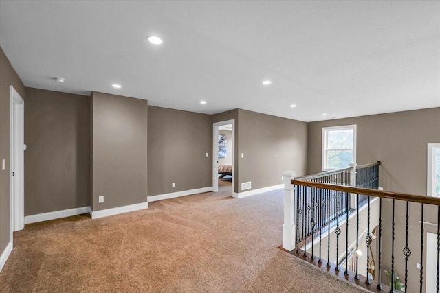 unfurnished room with light colored carpet