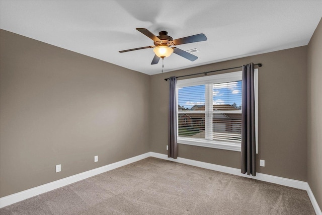 empty room featuring ceiling fan and light carpet