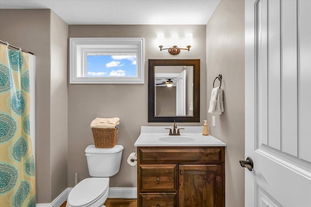 bathroom featuring vanity, ceiling fan, and toilet