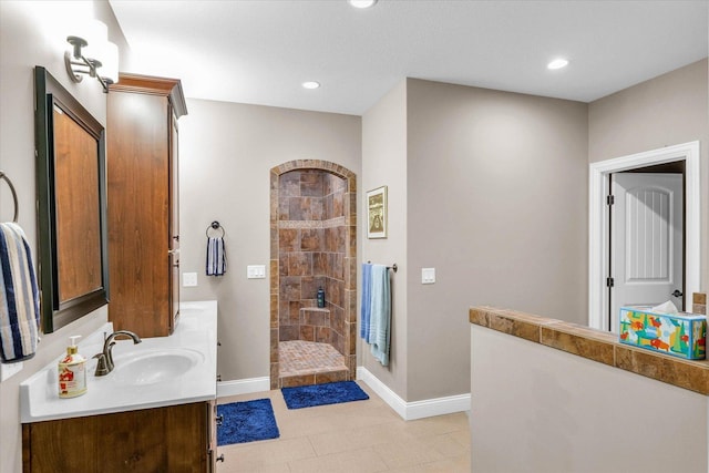 bathroom featuring vanity and tiled shower