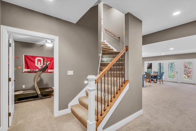 staircase featuring carpet flooring and ceiling fan