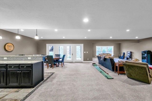 carpeted living room featuring a textured ceiling