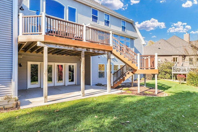 rear view of house featuring a lawn, a patio, and a deck