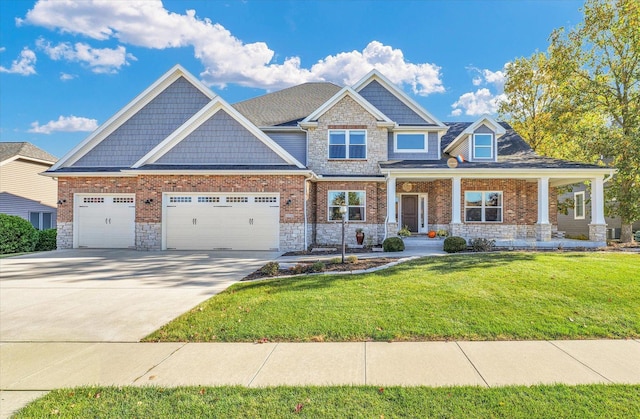 craftsman-style house featuring a front yard, a porch, and a garage