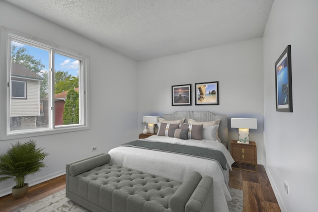 bedroom featuring a textured ceiling and wood-type flooring