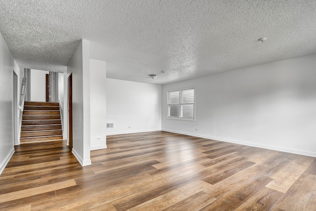 unfurnished room featuring a textured ceiling and wood-type flooring