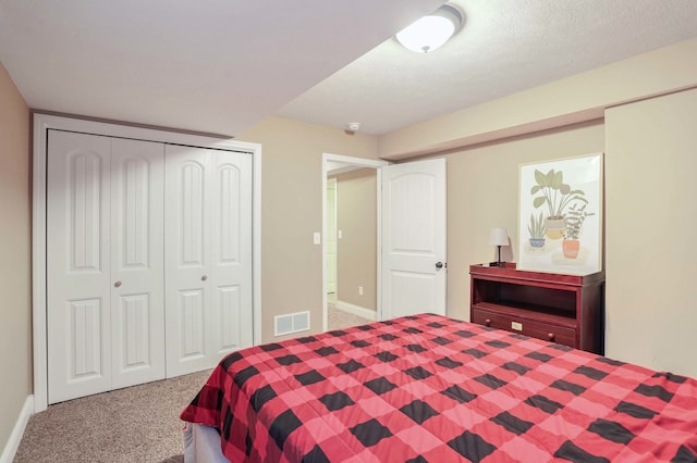 carpeted bedroom featuring a closet and a textured ceiling