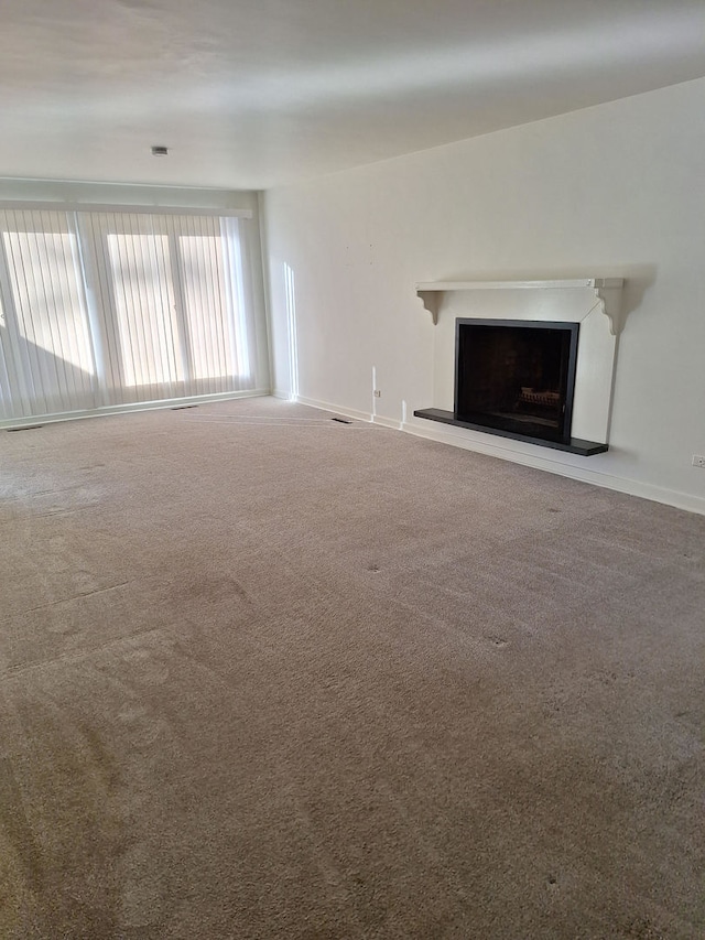 unfurnished living room featuring carpet