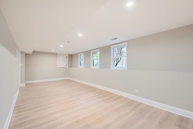 basement with light hardwood / wood-style floors