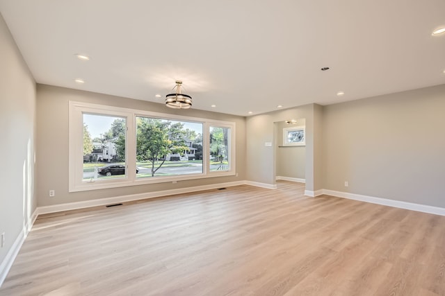 interior space featuring a notable chandelier and light wood-type flooring