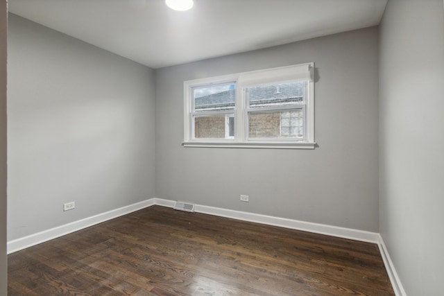 empty room with dark hardwood / wood-style floors