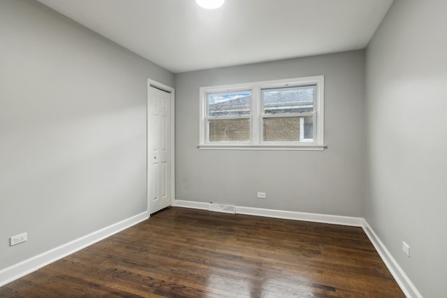 unfurnished room featuring dark hardwood / wood-style flooring