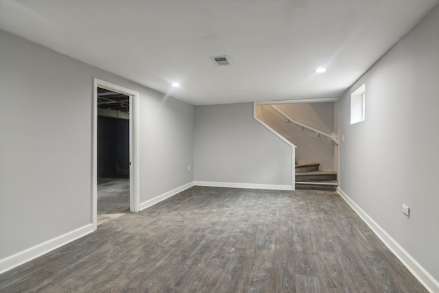 basement with dark hardwood / wood-style floors