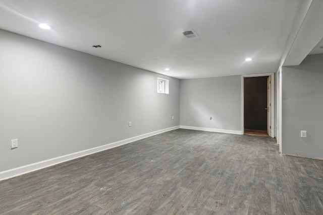 basement with dark hardwood / wood-style floors