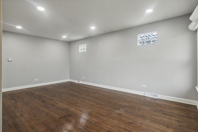 basement featuring dark hardwood / wood-style flooring