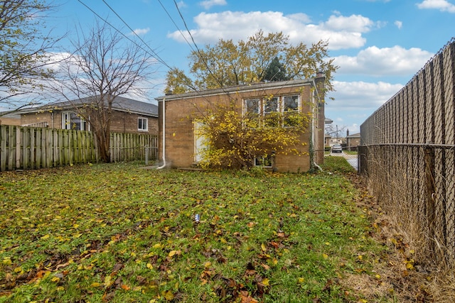 rear view of property with a lawn