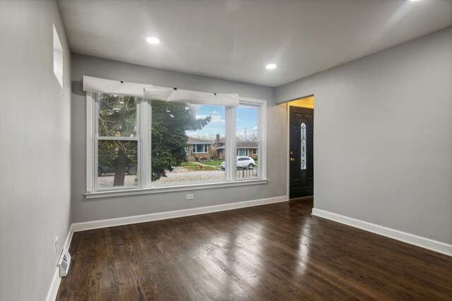 unfurnished room featuring dark wood-type flooring