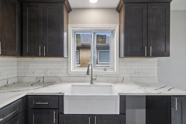 kitchen featuring light stone countertops and decorative backsplash