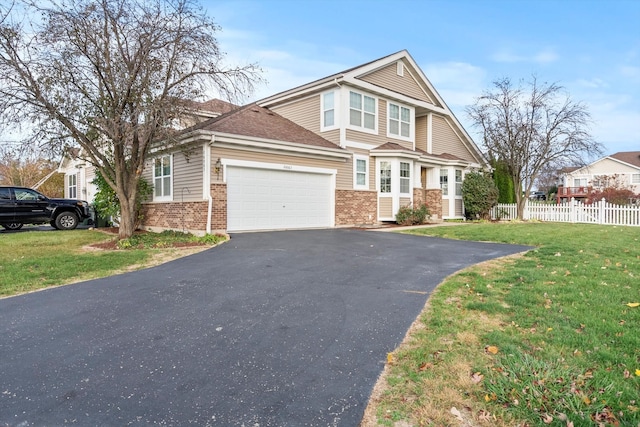 view of front of property with a front lawn and a garage