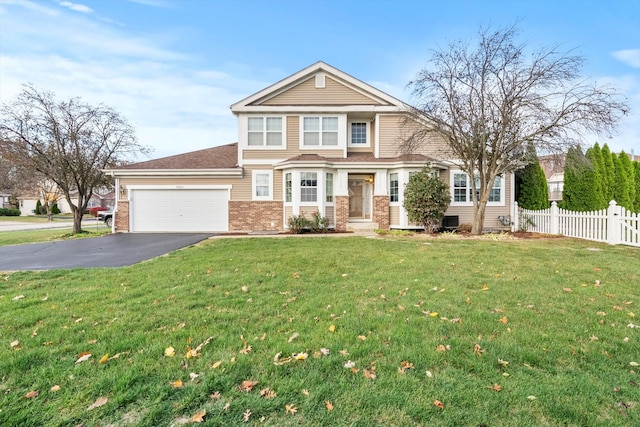 view of front of house with a front yard and a garage