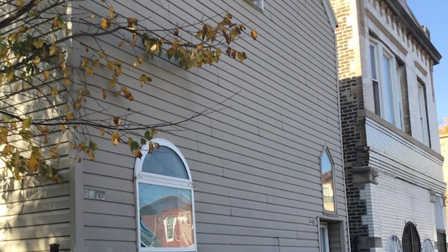 view of side of home featuring brick siding