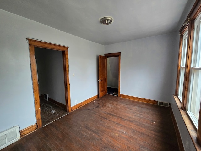 spare room with dark wood-type flooring