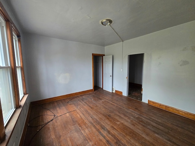 unfurnished room with dark hardwood / wood-style floors